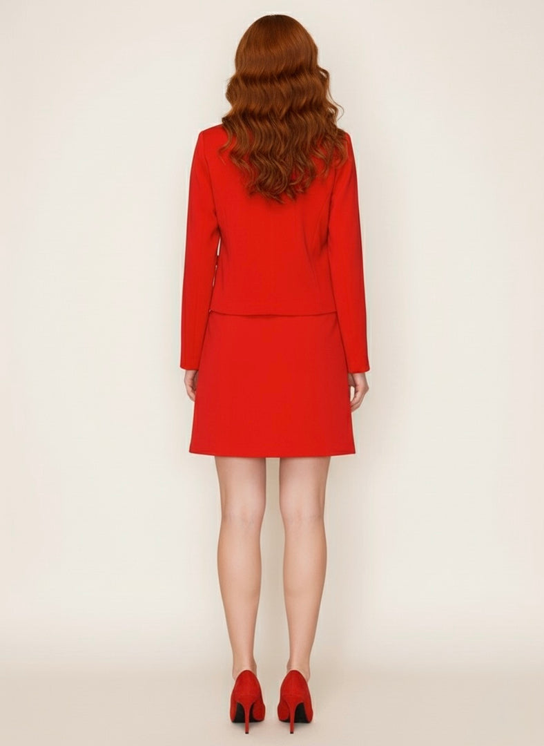 Person wearing a red suit with matching shoes on a white background