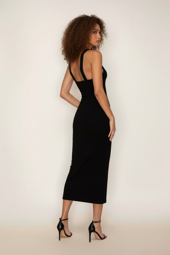 A sleek and sculpting black midi dress with an asymmetric halter neckline and metal ring detail—elegant, minimal, and irresistibly flattering.