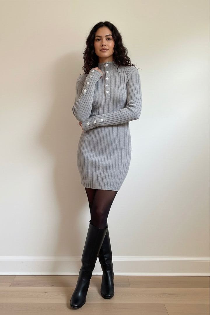 A chic grey ribbed knit mini dress featuring long sleeves, a mock neck, and elegant button details. Soft, stretchy, and perfect for fall/winter day-to-night outfits. Shop Bougieque.